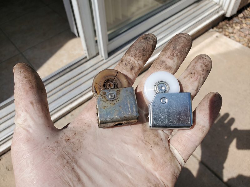 An old roller with a cracked, worn wheel held beside its new replacement in an open hand